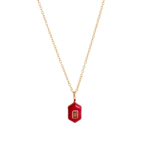 Detail view of gold-plated necklace featuring a red hexagonal pendant with center stone