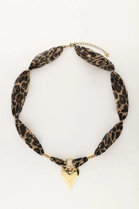 Detalle del collar de tela con estampado de leopardo y colgante de corazón dorado con cierre