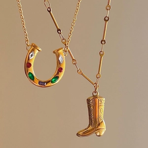 Golden horseshoe and western boot pendant necklaces with colorful stones and engraving
