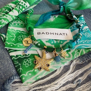 Bohemian velvet rope chain with starfish, evil eye, and shell charms in turquoise