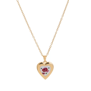 Detailed macro view of heart-shaped gold pendant with elegant red rose floral pattern