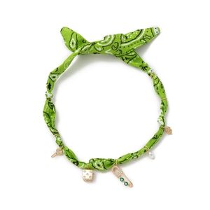 Green paisley headband necklace with gold charms like a key, dice, and faux pearl