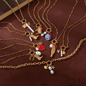 Vintage gold layered necklace with custom charms including boots, pearls, and heart pendants