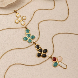Detailed shot of gold titanium cross necklaces with colorful pebble effect enamel inlays