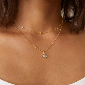 Double-layered 18K gold plated necklace with star charms and light blue stone pendant