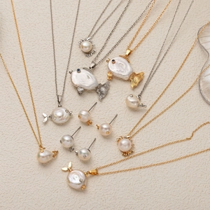 Ocean-themed jewelry set featuring baroque pearl whale, crab, and fish pendants in gold