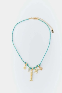 Detailed view of ocean style braided necklace with shell, starfish, and pearl pendants