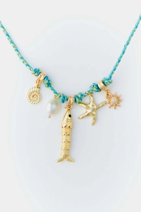 Detail of colorful braided cord necklace featuring gold starfish, shell and pearl pendants
