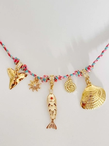 Detail of summer beach rope necklace with golden shell, sun, and fish charms