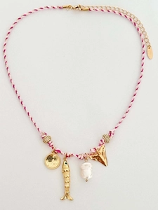 Detail of pink woven cord necklace with gold fish, pearl, and shark tooth charms