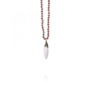 Detailed macro view of deep purple gemstone beads and a white cone pendant with gold plating