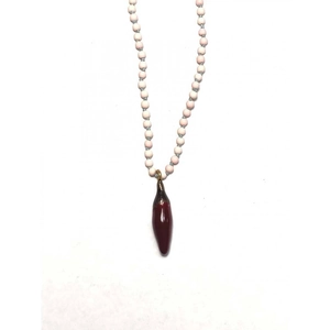 Beaded necklace with light pink pearls and a deep red chili pepper pendant in 18k gold
