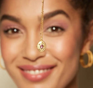 Detail of 18k gold stainless steel necklace featuring a pink gemstone oval pendant