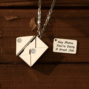 Detailweergave van zilveren enveloppe ketting van titanium met gravure voor moeders