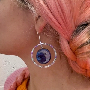 Bohemian large hoop earrings with colorful beads and personified moon pendant on model