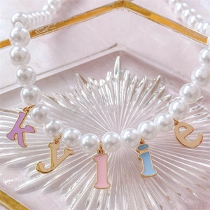 Pearl necklace with Kylie enamel letter pendants in 18K gold-plated stainless steel