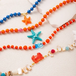 Summer ocean themed colorful beaded necklace with shell, starfish and crab charms