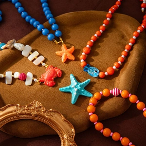 Ocean themed beaded necklace with sea star, crab and fish pendants for summer beach style