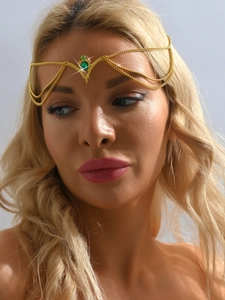 Detail of bohemian gold head chain with green teardrop crystal on blonde model