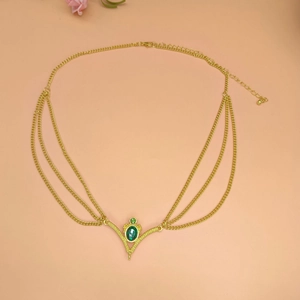 Gold chain bridal headpiece with green gemstones and layered ethnic tassel style