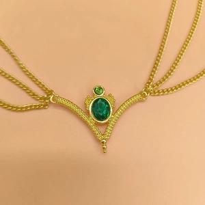 Ethnic gold bridal head chain jewelry featuring green gemstone pendants and layered tassels