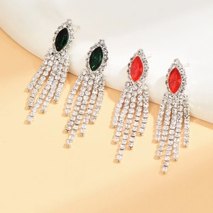 Detailed macro view of luxury marquise gemstone tassel earrings in emerald green and ruby red