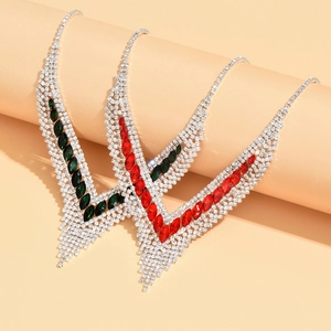 Macro detail of V-shaped luxury tassel necklaces with emerald and ruby rhinestones