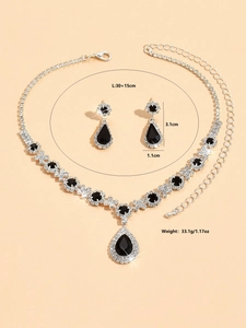 Detailed shot of pear-cut black crystal necklace and earrings set in silver finish