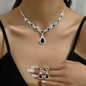 Elegant silver necklace and teardrop earrings set with deep black crystals for women