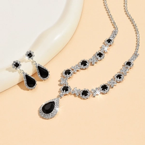 Macro shot of silver crystal necklace and black teardrop pendant jewelry set