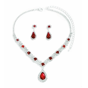 Macro shot of silver plated jewelry set with red teardrop crystals and clear zircon accents