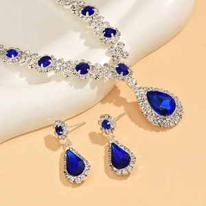 Detailed view of teardrop crystal jewelry set with navy blue stones and silver finish
