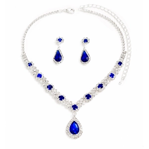 Macro shot of silver-tone necklace and teardrop blue crystal earrings jewelry set