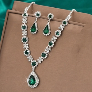 Macro view of crystal teardrop necklace and earrings set on a velvet display box