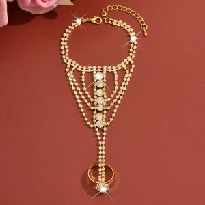 Close-up of golden finger bracelet with rhinestones and adjustable lobster clasp closure