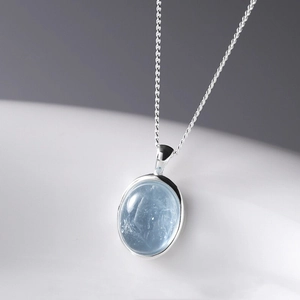 Elegant oval blue moonstone pendant necklace with a polished silver snake chain finish