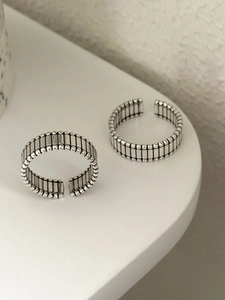 Detailed macro view of S925 sterling silver retro rings with vertical stripes and bead edges