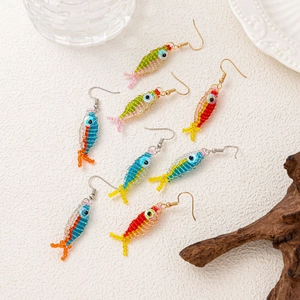 Detail of colorful handmade beaded fish earrings with intricate woven patterns and gold hooks