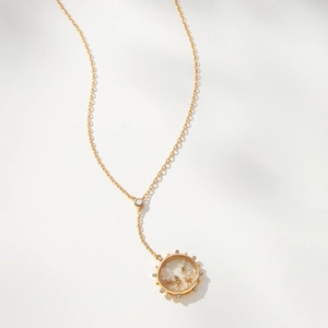 Détail du médaillon en or 18 carats avec charmes célestes de lune et d'étoiles