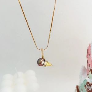 Nahaufnahme von Perlenanhänger mit Diamantverschluss und goldener Gliederkette