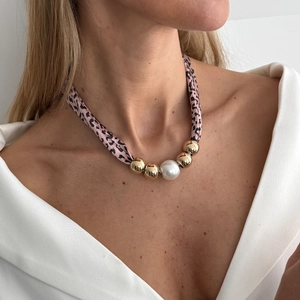 Detail van luipaardprint zijden ketting met grote parel en gouden kraalaccenten