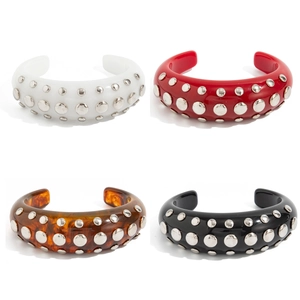 Punk resin cuff bracelets set with metal studs in white, red, amber, and black finishes