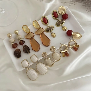 Collection of vintage geometric resin drop earrings with gold metal accents
