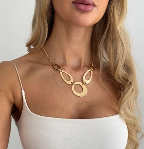 Detailed close-up of high-shine gold irregular O-ring waist chain on a model