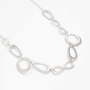 Detail of silver irregular O-shaped geometric hollow metal links on a stylish waist chain
