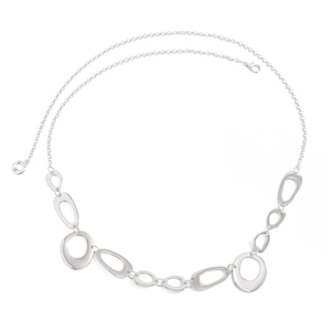 Detailed close-up of irregular O-shaped metal rings and lobster clasp body chain