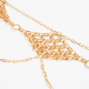 Detail shot of golden metal waist chain featuring a woven diamond mesh pattern