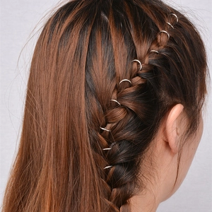 Silver metal dreadlock rings hair accessories on model with fishtail braid