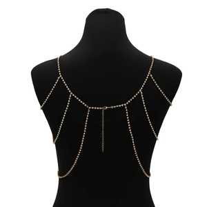 Close-up of golden multilayer tassel body chain with sparkling rhinestones on model