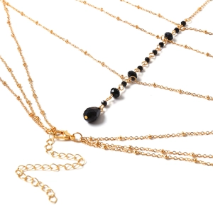 Chaîne de corps dorée multicouche élégante avec perles en cristal noir et pendentif goutte